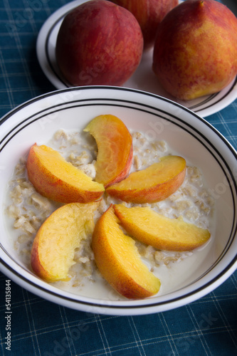 Peaches oatmeal on a blue tablecloth served