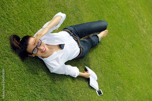 Young woman reading a book in the park