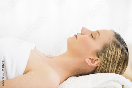 Beautiful Woman Resting On Massage Table In Health Spa