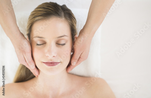 Relaxed Woman Receiving Head Massage In Health Spa