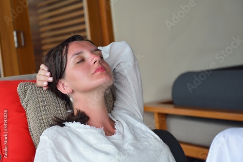 happy young woman relax at home on sofa