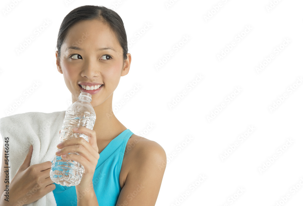 Happy Woman With Towel And Water Bottle Looking Sideways Happy Woman With Towel And Water Bottle Looking Sideways