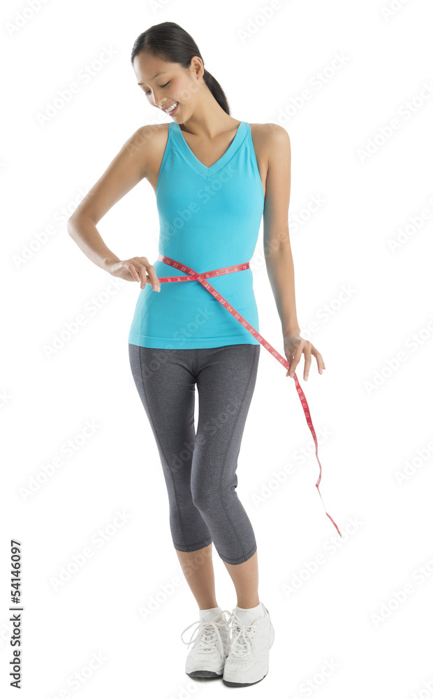 Happy Woman In Sports Clothing Measuring Her Waistline Happy Woman In Sports Clothing Measuring Her Waistline