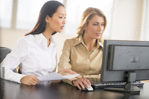 Businesswomen Using Desktop PC