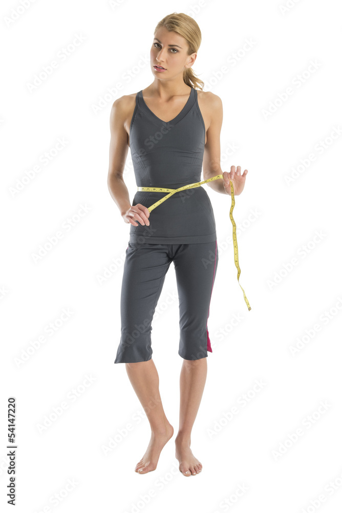 Frustrated Woman Holding Tape Measure Around Waist Frustrated Woman Holding Tape Measure Around Waist
