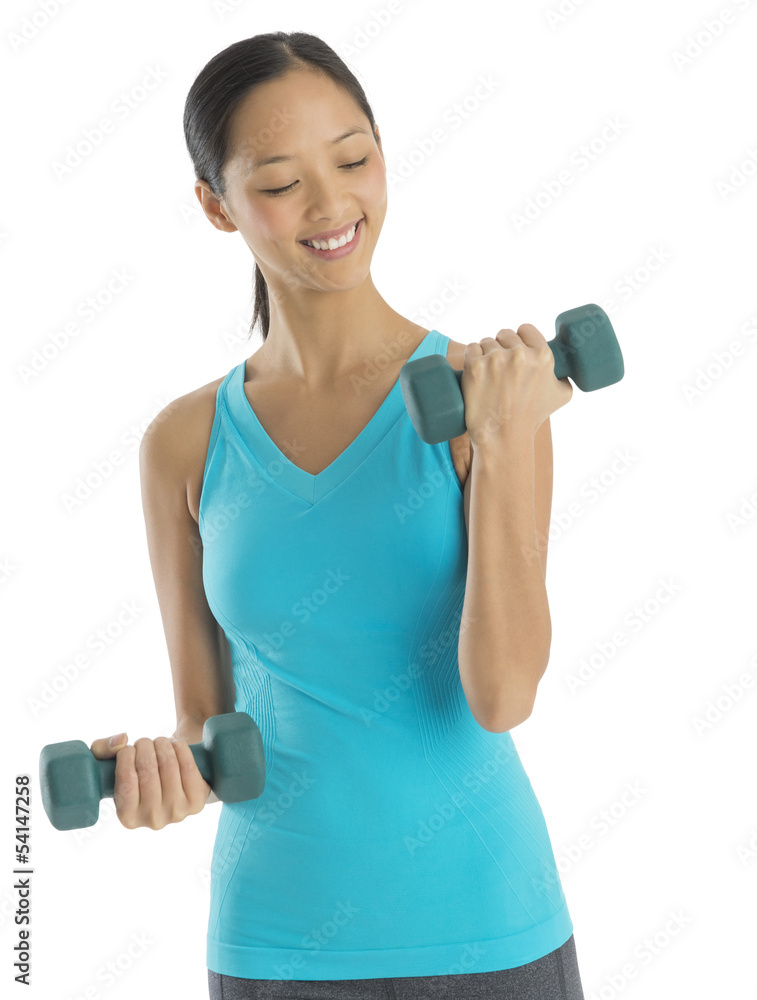 Happy Mid Adult Woman Lifting Dumbbells Happy Mid Adult Woman Lifting Dumbbells