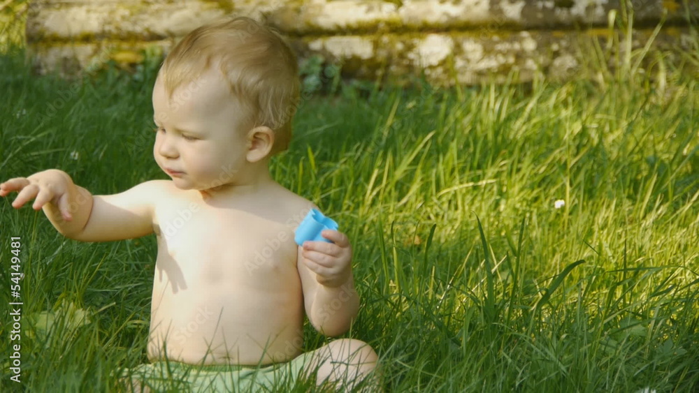 HD1080p25 Little baby playing with color blocks on green meadow. HD1080p25 Little baby playing with color blocks on green meadow.