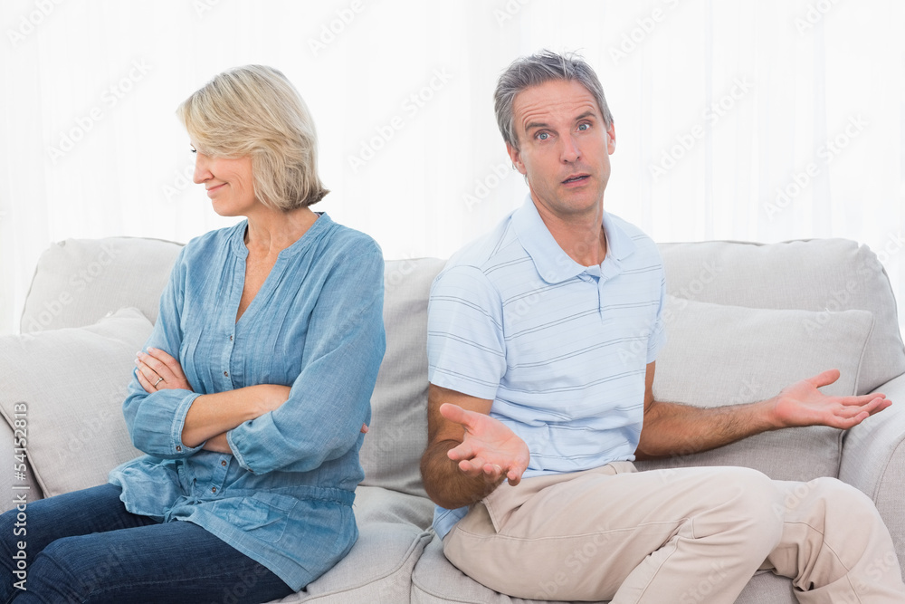 Couple not taking after a fight and man looking confused at came Couple not taking after a fight and man looking confused at came