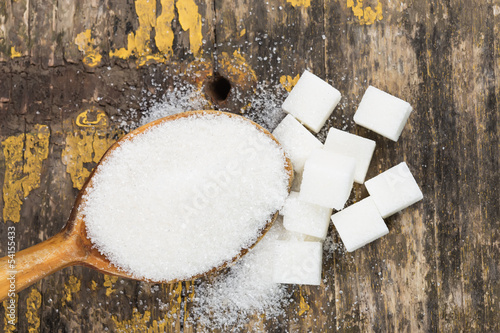 Sugar on wooden background photo