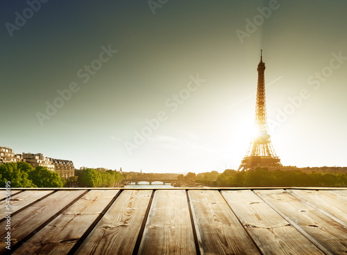 background with wooden deck table and  Eiffel tower in Paris © Iakov Kalinin