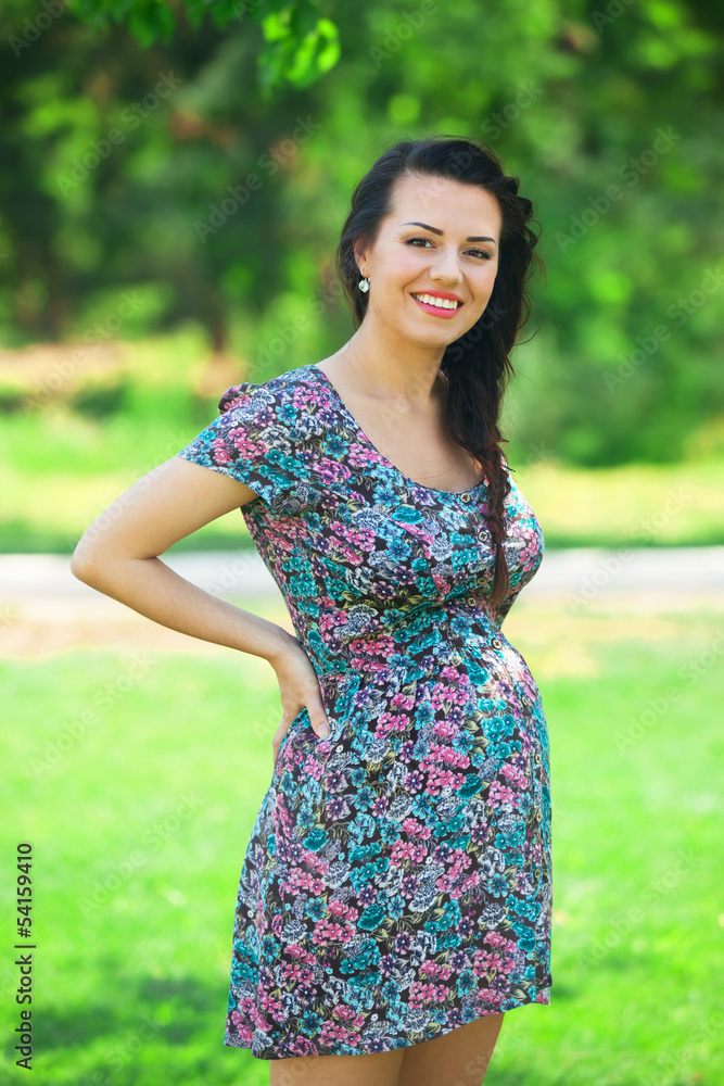 Young beautiful pregnant woman in the park Young beautiful pregnant woman in the park