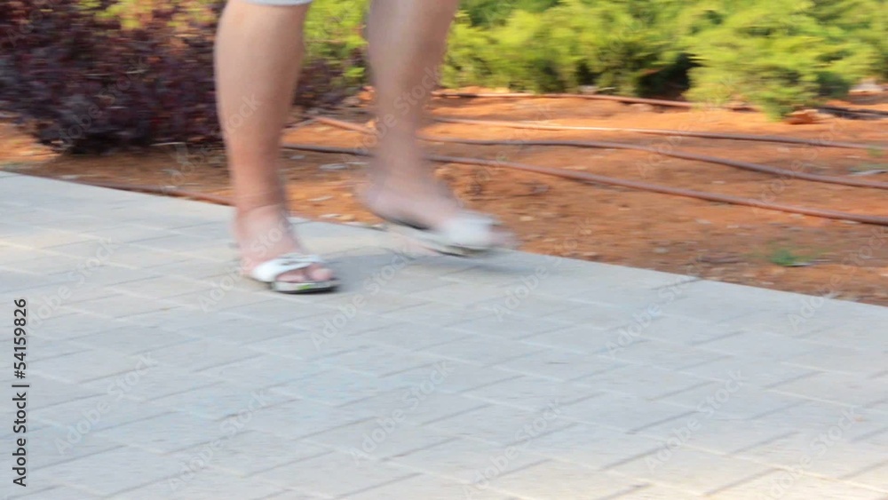 Man running in small women slippers Man running in small women slippers
