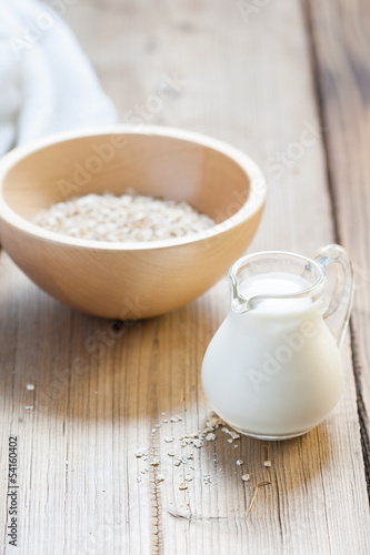 Wooden bowls and a small jug on the wooden background