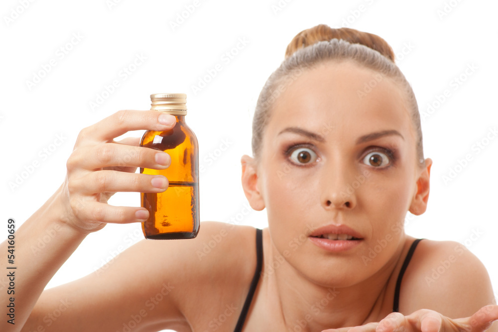 Fototapeta premium woman holding a bottle of medicine, isolated on white background