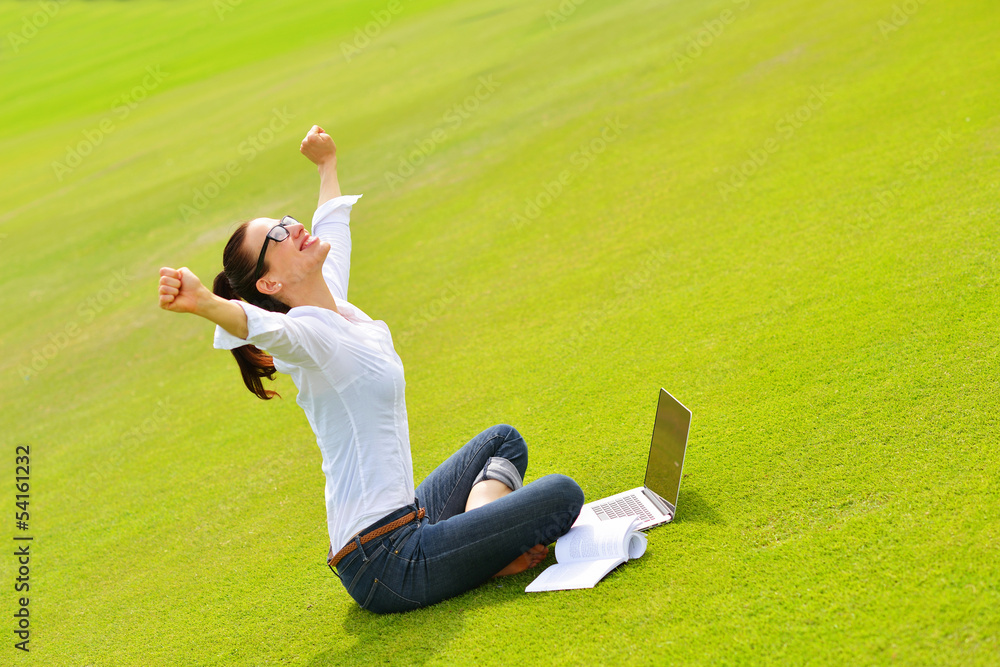 woman with laptop in park