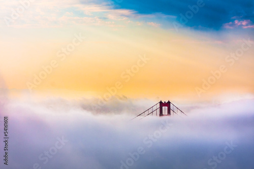World Famous Golden Gate Bridge in thich Fog after Sunrise
