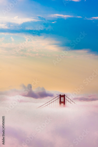 World Famous Golden Gate Bridge in thich Fog after Sunrise photo