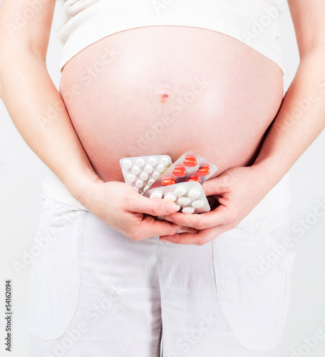 Pregnant woman with tablets