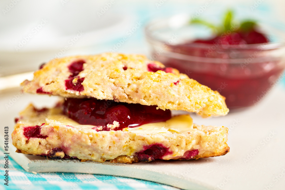 Scone with orange zest and berries with butter and jam Scone with orange zest and berries with butter and jam