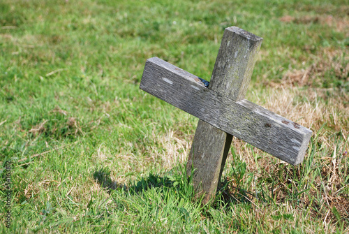 Small wooden cross in a graveyard