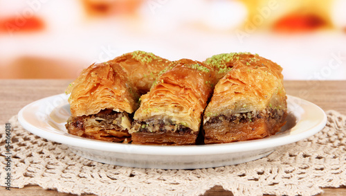Sweet baklava on plate on table in room