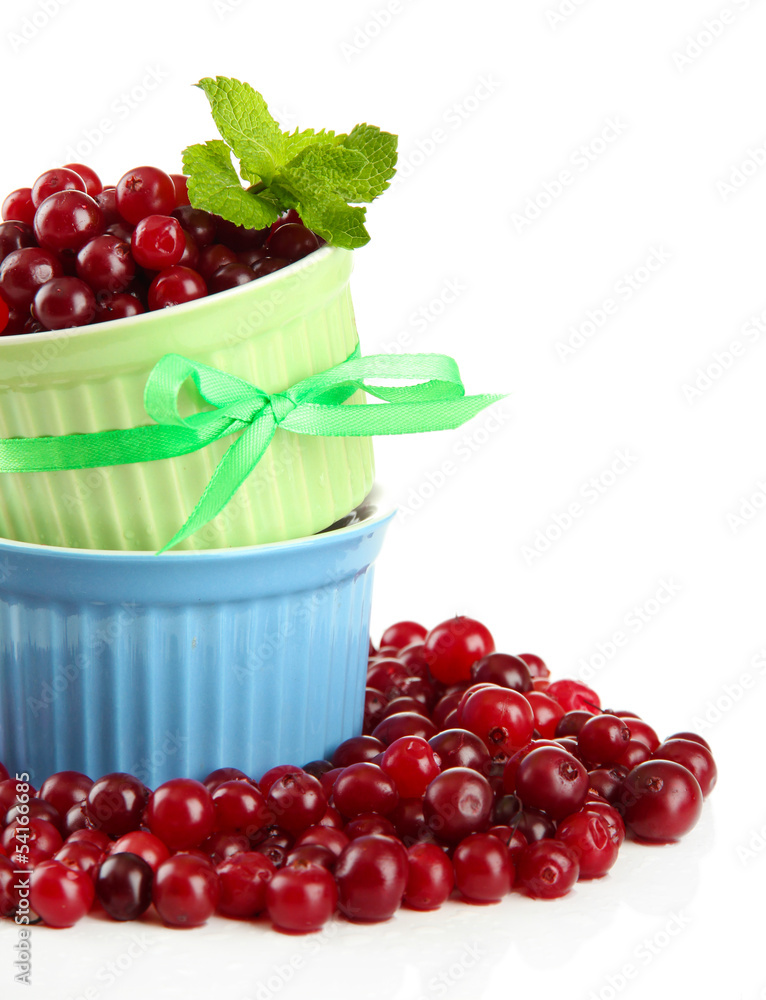 Ripe red cranberries in bowls, isolated on white. Ripe red cranberries in bowls, isolated on white.