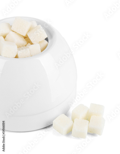 Refined sugar in white sugar bowl on grey background photo