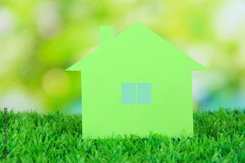 Paper house on grass on natural background Paper house on grass on natural background