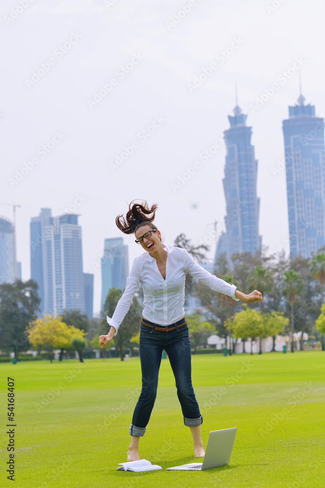 woman with laptop in park