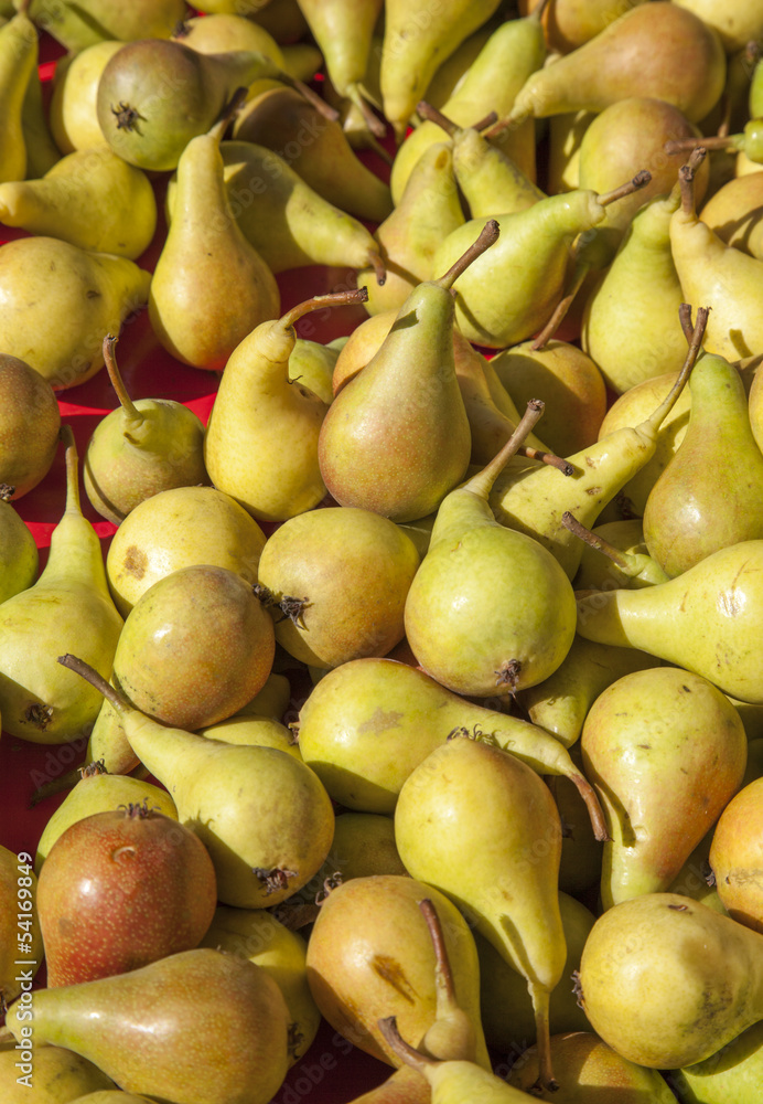 Fresh organic pears on happy sunny market