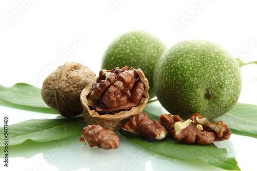 walnuts with green leaves isolated on white