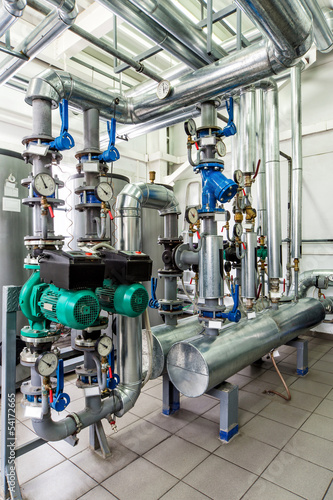 interior gas boiler room with multiple pumps and piping
