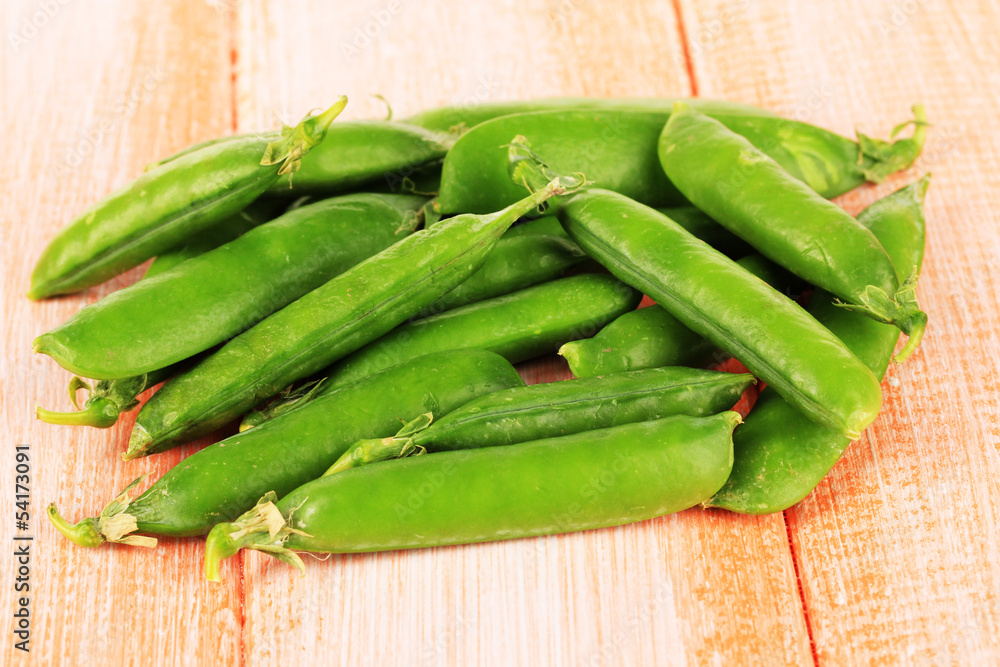 Sweet green peas on wooden background Sweet green peas on wooden background
