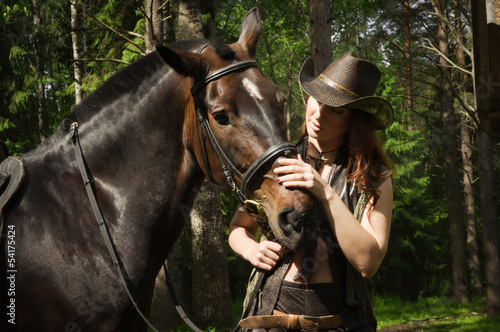 Cowgirl and brown horse © Demian
