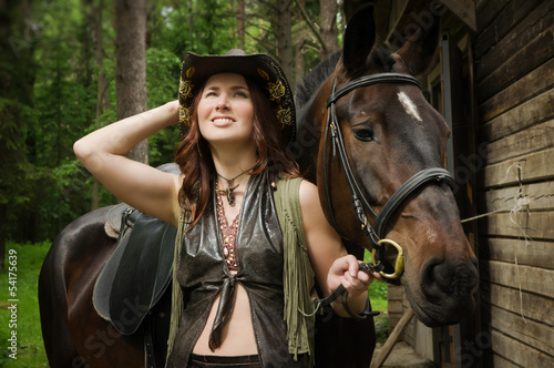 Cowgirl with brown horse © Demian