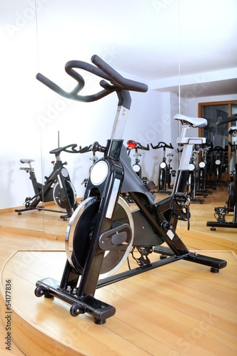 Group of spinning bicycles at fitness studio
