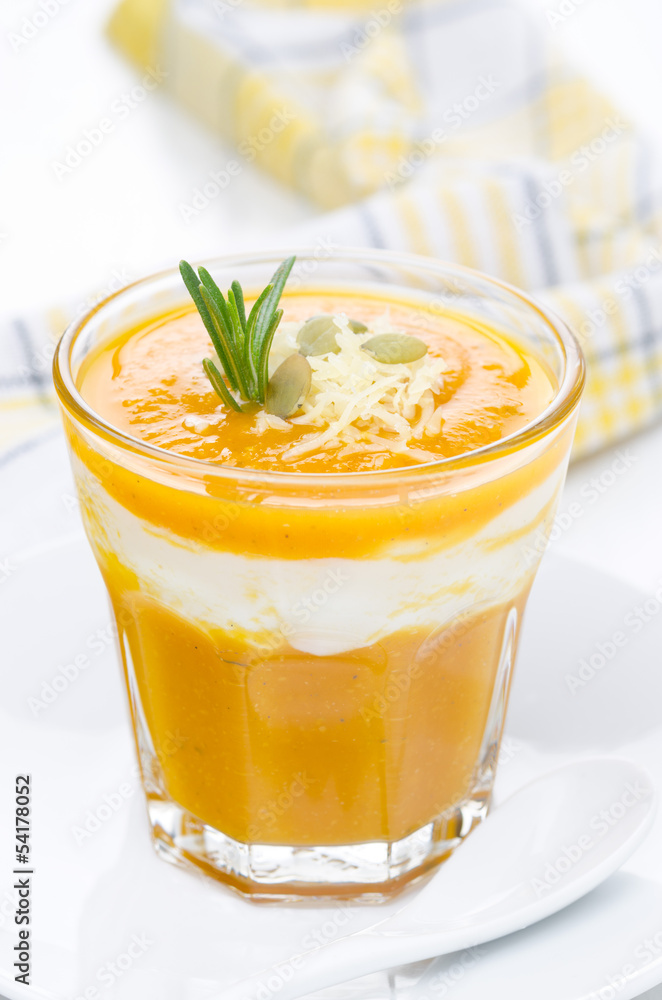 pumpkin soup with shrimp, yogurt and rosemary in a glass closeup pumpkin soup with shrimp, yogurt and rosemary in a glass closeup