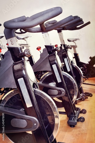 Group of spinning bicycles at fitness studio