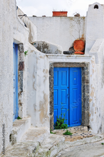 Old house with blue traditional door in Pyrgos © tobago77