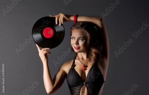 Sexy young woman in retro style with vinyl plate