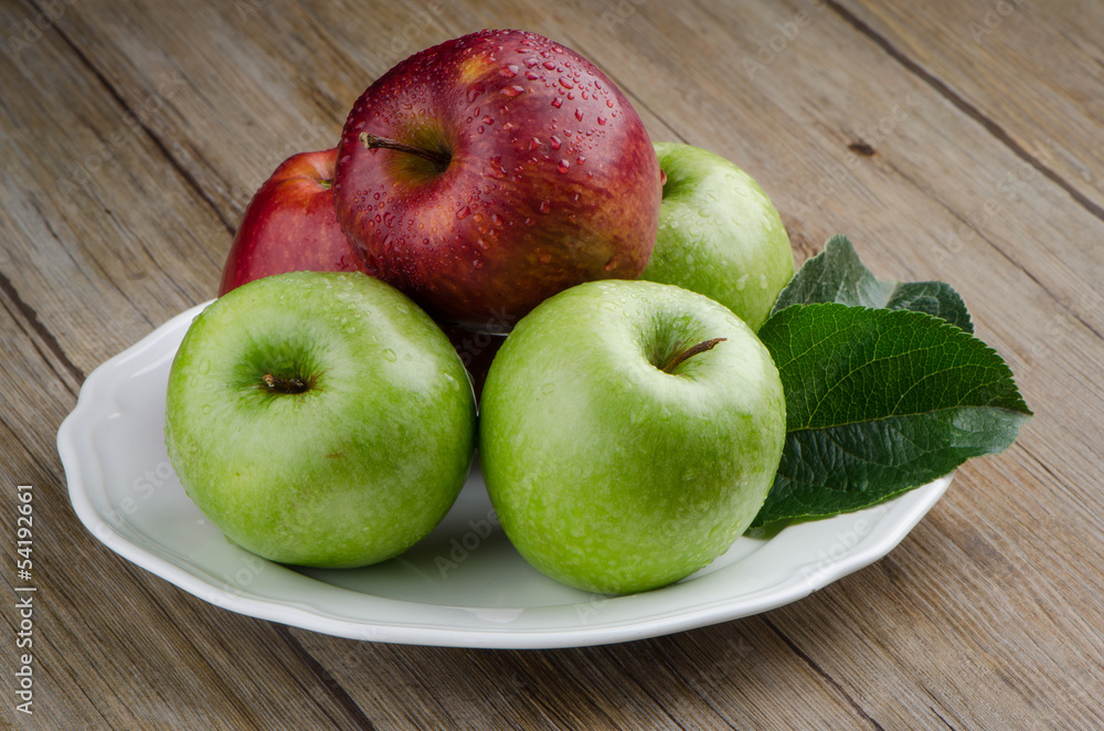 Apples in a ceramic white plate Apples in a ceramic white plate