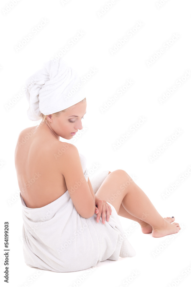 back-view of a young woman in towel sitting on white back-view of a young woman in towel sitting on white