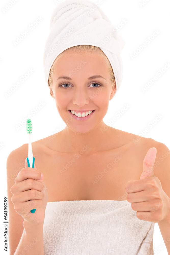 attractive woman with toothbrush and towel thumbs up over white attractive woman with toothbrush and towel thumbs up over white