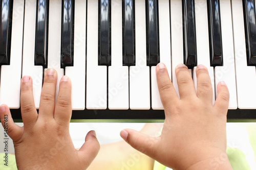 Hand of the boy. Playing the piano