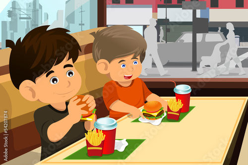 Kids eating hamburger and fries