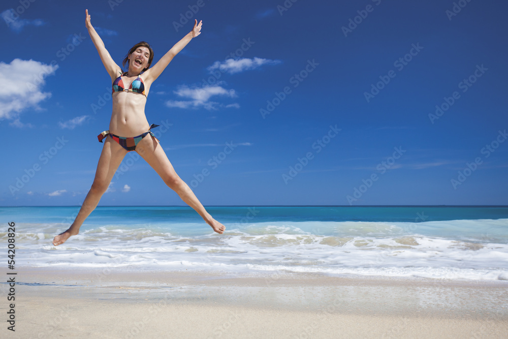Woman jumping on the beach Woman jumping on the beach