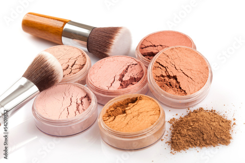 Face powder and brush on white background