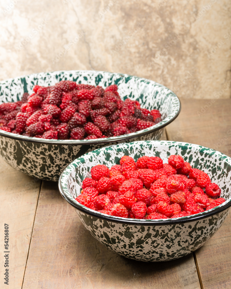 Bowls of red raspberries and tayberries Bowls of red raspberries and tayberries
