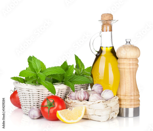 Fototapeta Naklejka Na Ścianę i Meble -  Fresh herbs, tomato, olive oil and pepper shaker