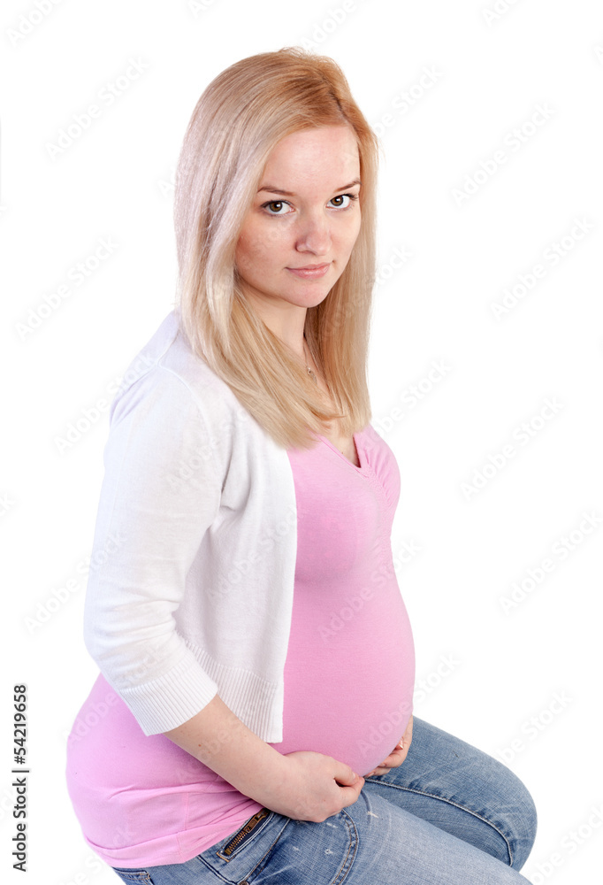 Beautiful young pregnant blonde girl in studio shot on white Beautiful young pregnant blonde girl in studio shot on white